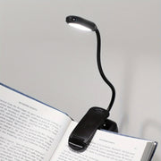 WinniHouse LED desk lamp with adjustable arm and clip, battery-powered, modern ergonomic design for reading at home or office.