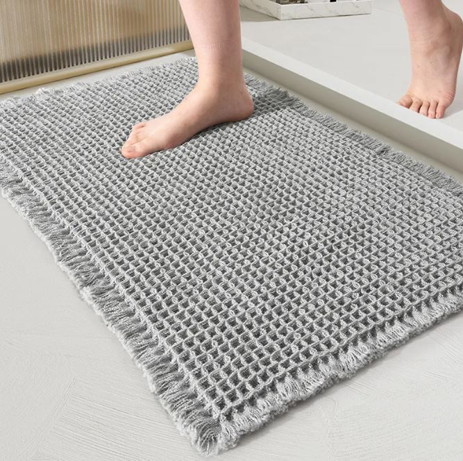 Absorbent waffle-texture non-slip bathroom rug by WinniHouse, featuring a soft, textured surface and safety grip for wet floors.