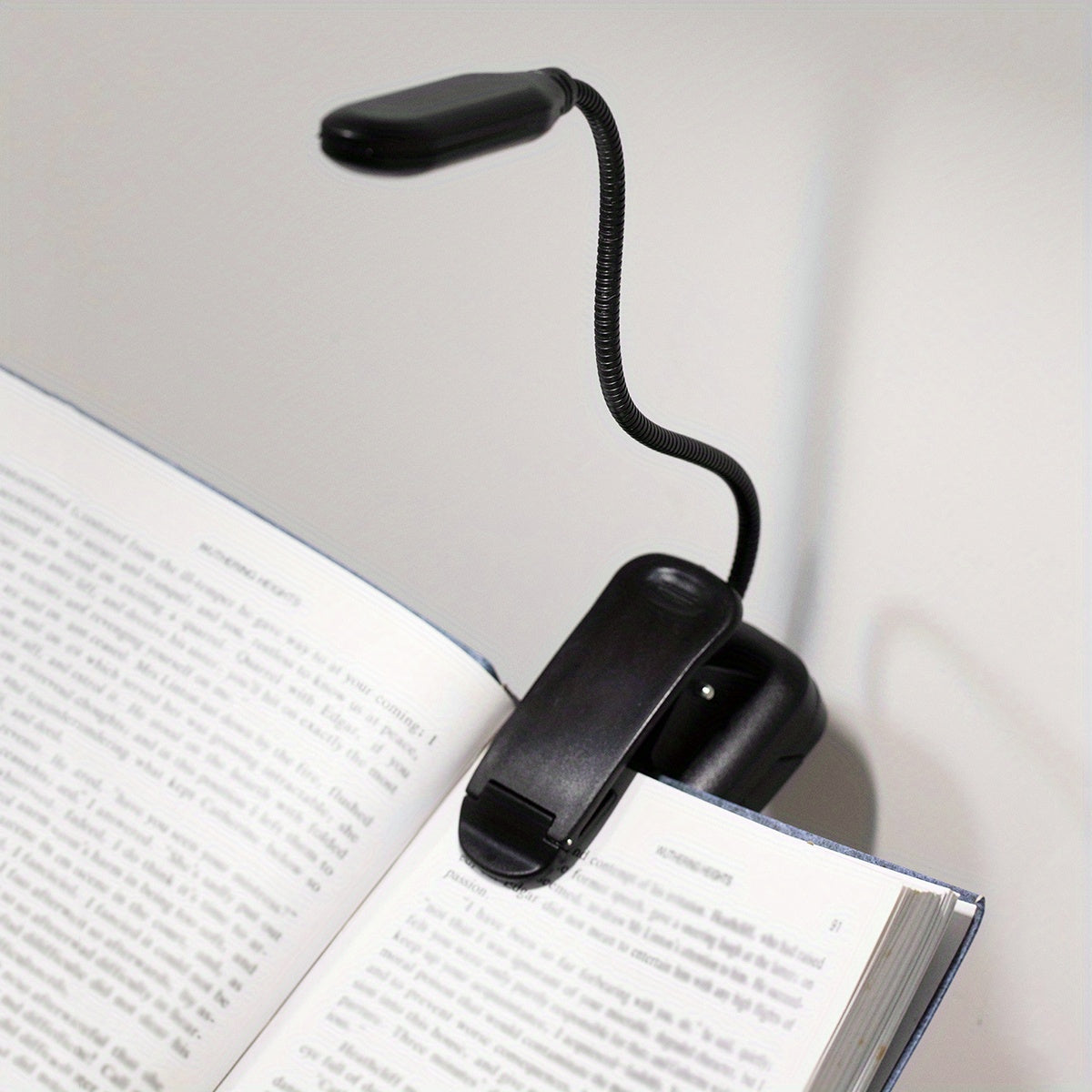 WinniHouse LED desk lamp with adjustable arm and clip, battery-powered, modern ergonomic design for reading at home or office.