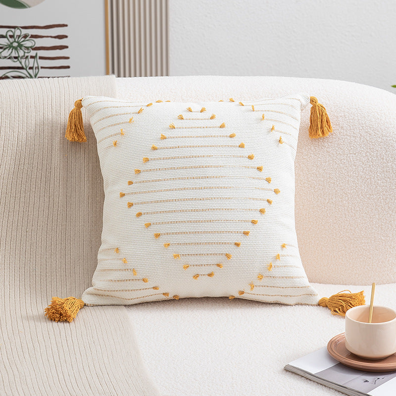 Boho cushion cover with tassels featuring geometric design in cotton by WinniHouse, showing textured fabric and decorative tassels.