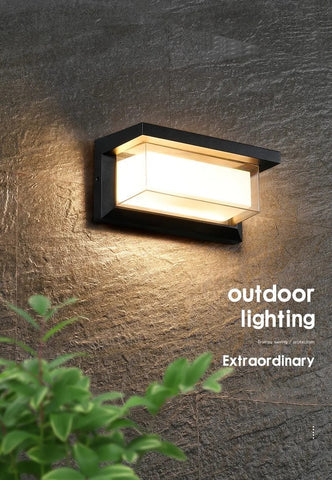 WinniHouse waterproof outdoor wall lamp mounted on garden wall, with a classic design and durable metal finish for exterior lighting.