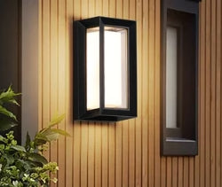 WinniHouse waterproof outdoor wall lamp mounted on garden wall, providing illumination for outdoor spaces.