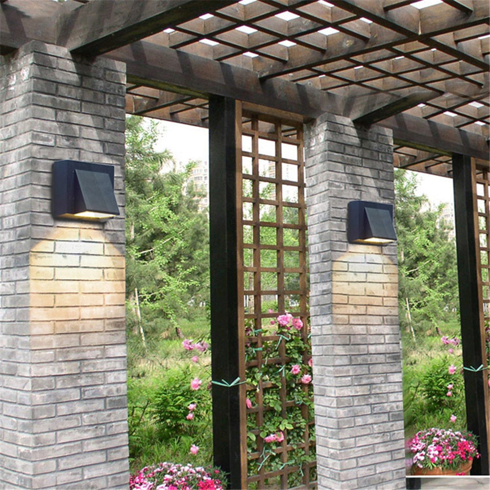 Waterproof wall lamp by WinniHouse mounted on outdoor courtyard background wall, suitable for exterior lighting.