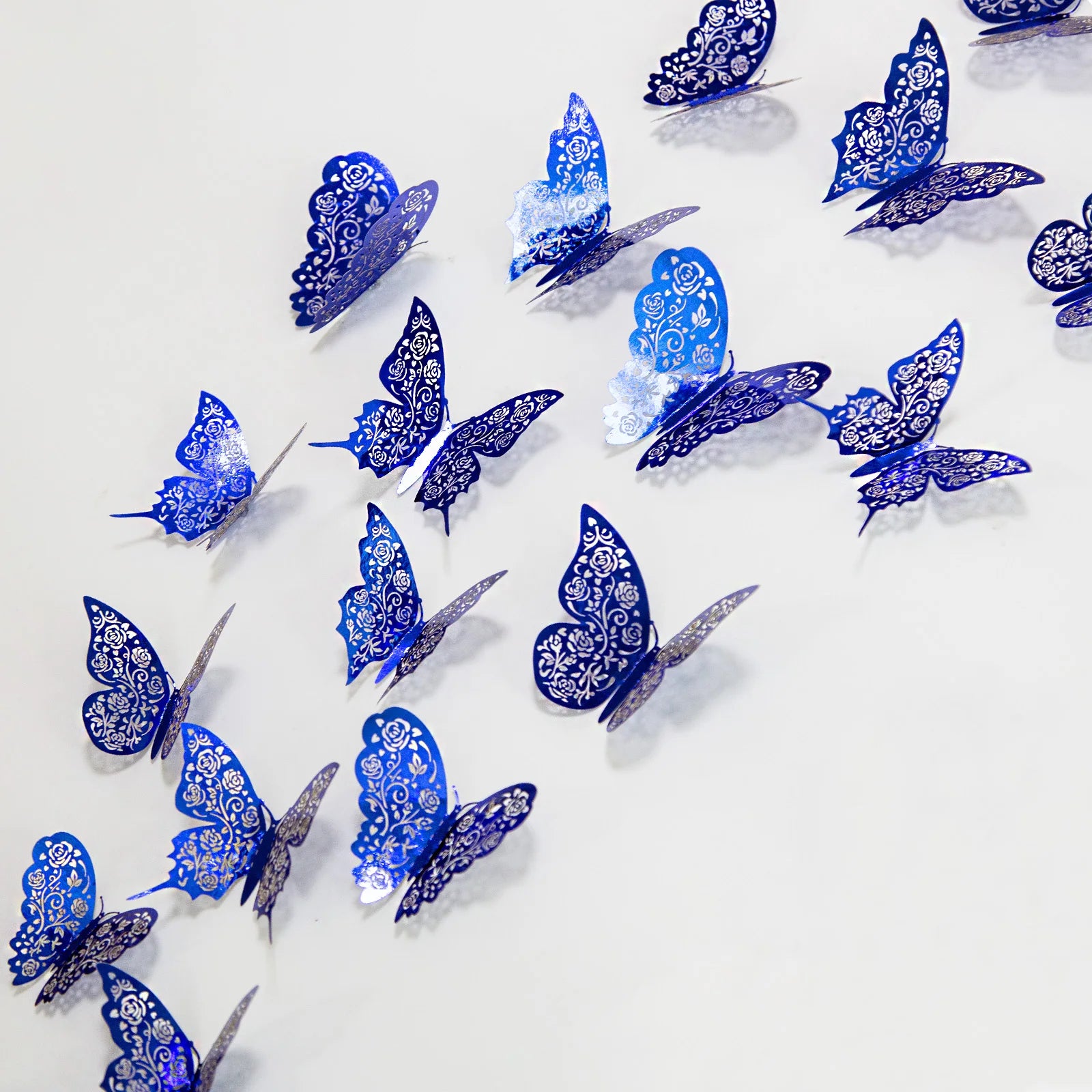 Blue 3D butterfly wall stickers by WinniHouse, featuring hollow design, perfect for decorating walls with a vibrant, artistic touch.