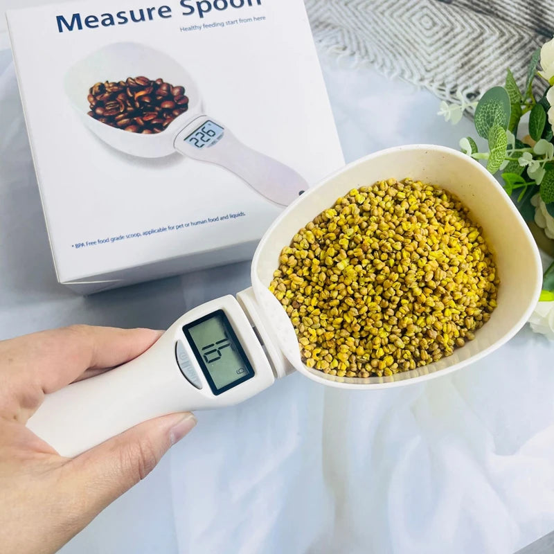 Digital food measuring spoon by WinniShop, used for precise pet food and flour measurements in the kitchen with a digital scale.