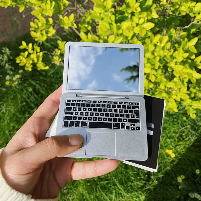 Portable creative mini makeup mirror with laptop design, foldable and high-quality, ideal for beauty touch-ups on the go.