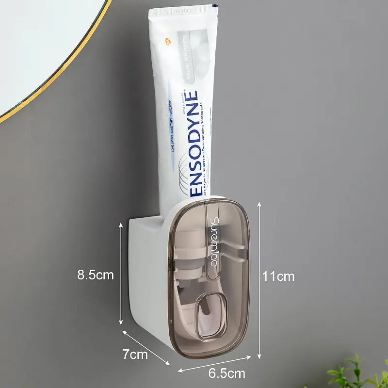 WinniHouse automatic toothpaste dispenser with sleek design, mounted on a bathroom wall, dispensing toothpaste smoothly.