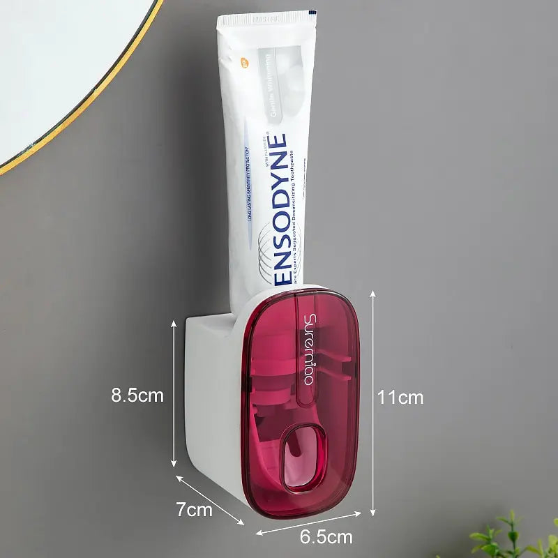 WinniHouse automatic toothpaste dispenser with sleek design, showing the device dispensing toothpaste onto a toothbrush.