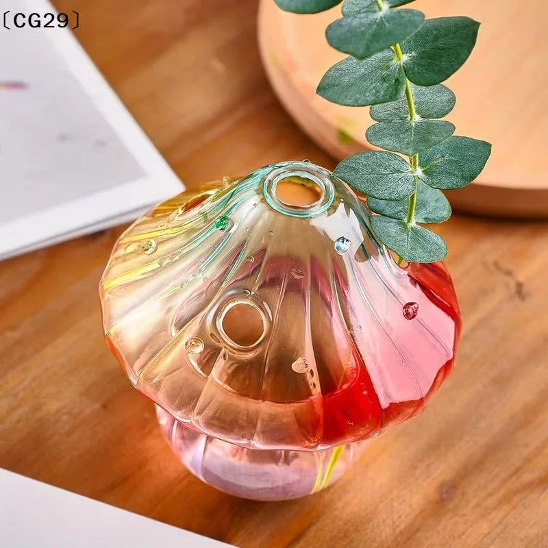 Colorful glass mushroom-shaped vase by WinniHouse with vibrant, translucent hues and a whimsical design.