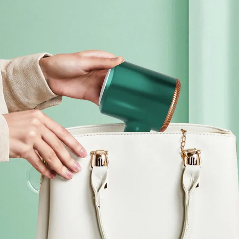 Portable electric lint remover for clothing, WinniShop, with a rechargeable depilation head for sweaters, plush fabrics, and fuzzy garments.