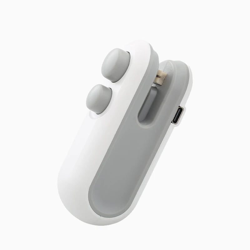 WinniShop mini handheld heat sealer for plastic food bags with clip, portable food packaging and sealing device in use.