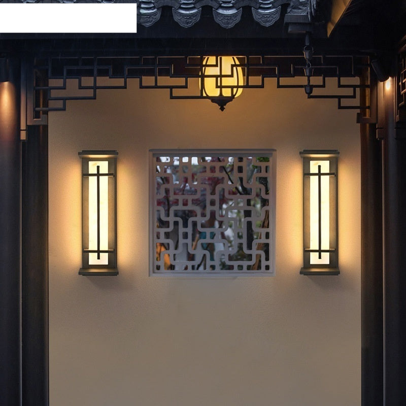 WinniHouse Strip Wall Lamp in garden setting, modern wall-mounted lighting fixture for outdoor or indoor use