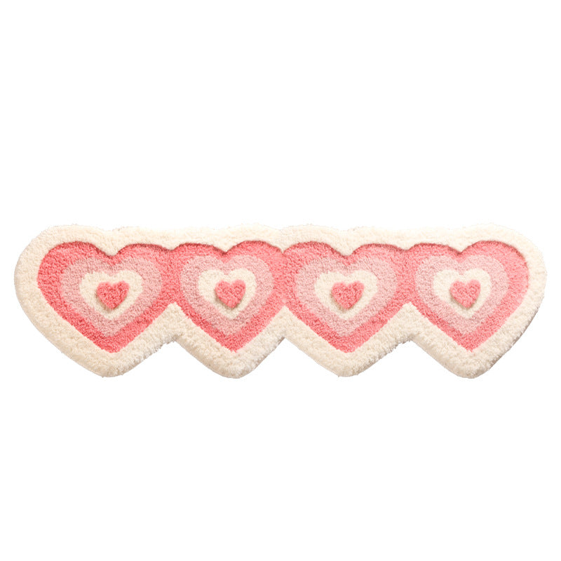 Soft pink heart-shaped shaggy rug from WinniHouse, plush and fluffy perfect for bedroom decor.