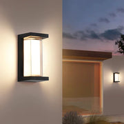 WinniHouse waterproof outdoor wall lamp installed on garden wall, providing stylish illumination for outdoor spaces.